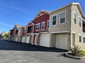 A row of brick houses with white garage doors